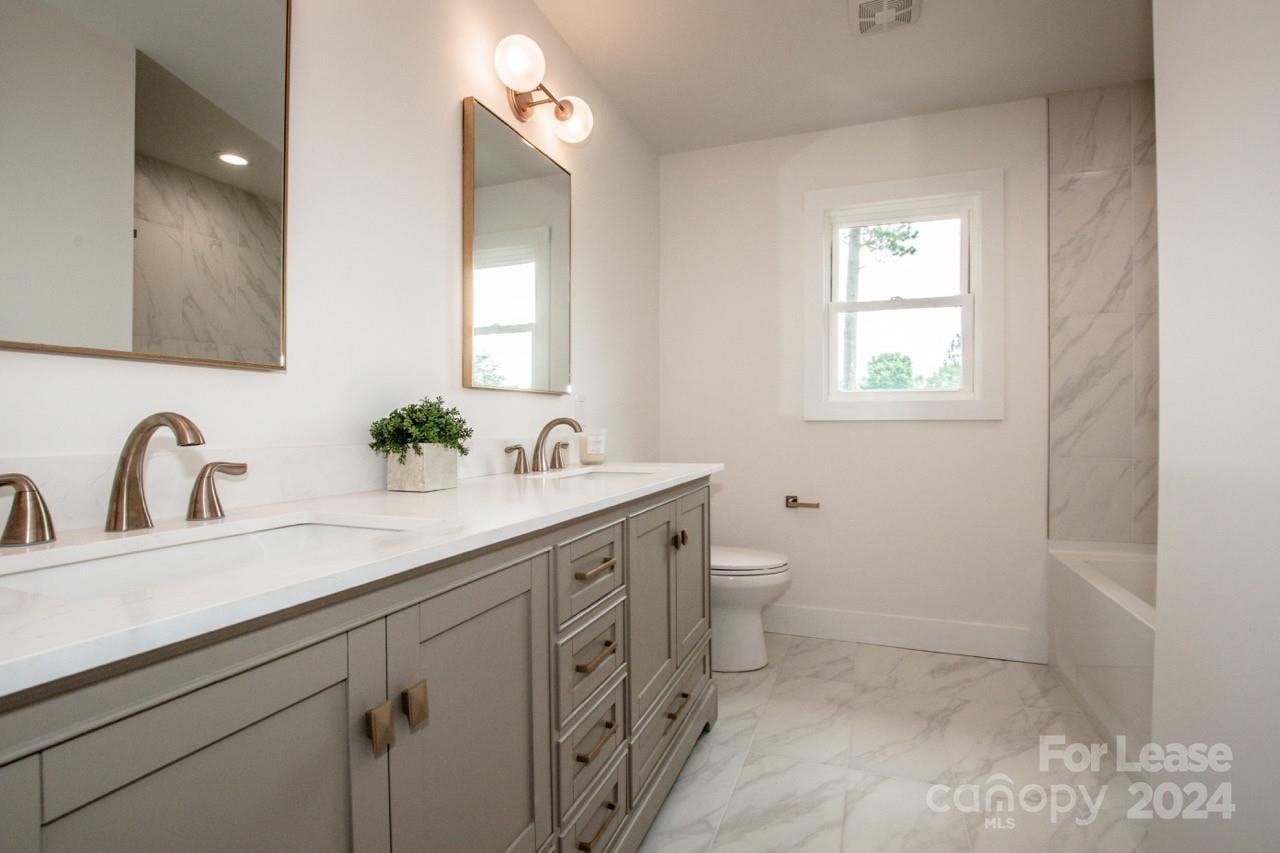 4892 Highway 16 Denver, NC 28037 - Photo 36 of 46 a bathroom with a double vanity sink and a mirror