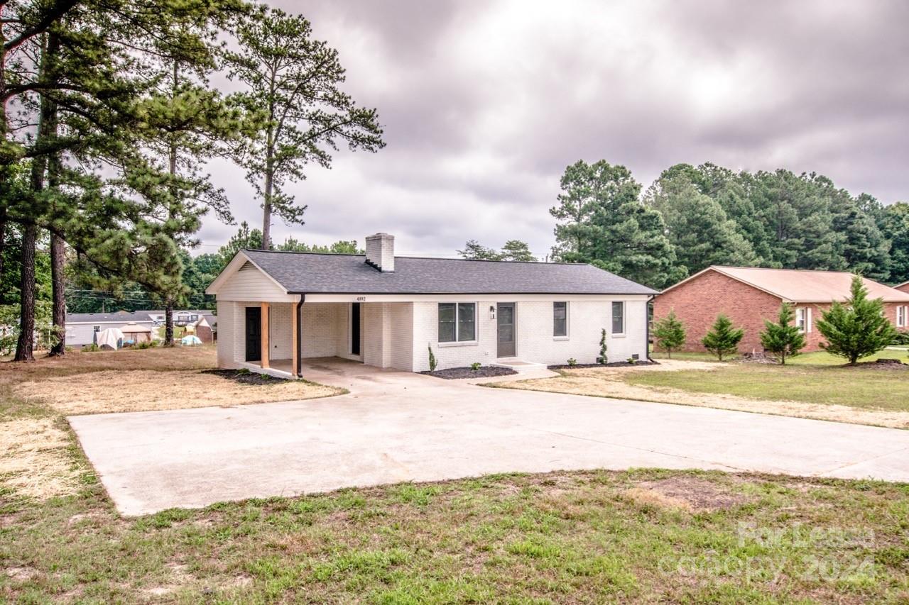 4892 Highway 16 Denver, NC 28037 - Photo 43 of 46 a front view of a house with a garden and pathway
