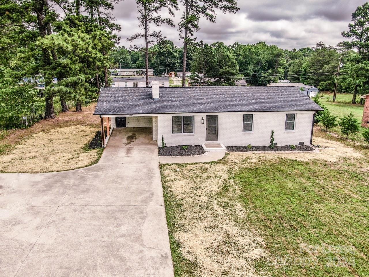 4892 Highway 16 Denver, NC 28037 - Photo 45 of 46 a aerial view of a house with swimming pool and large trees