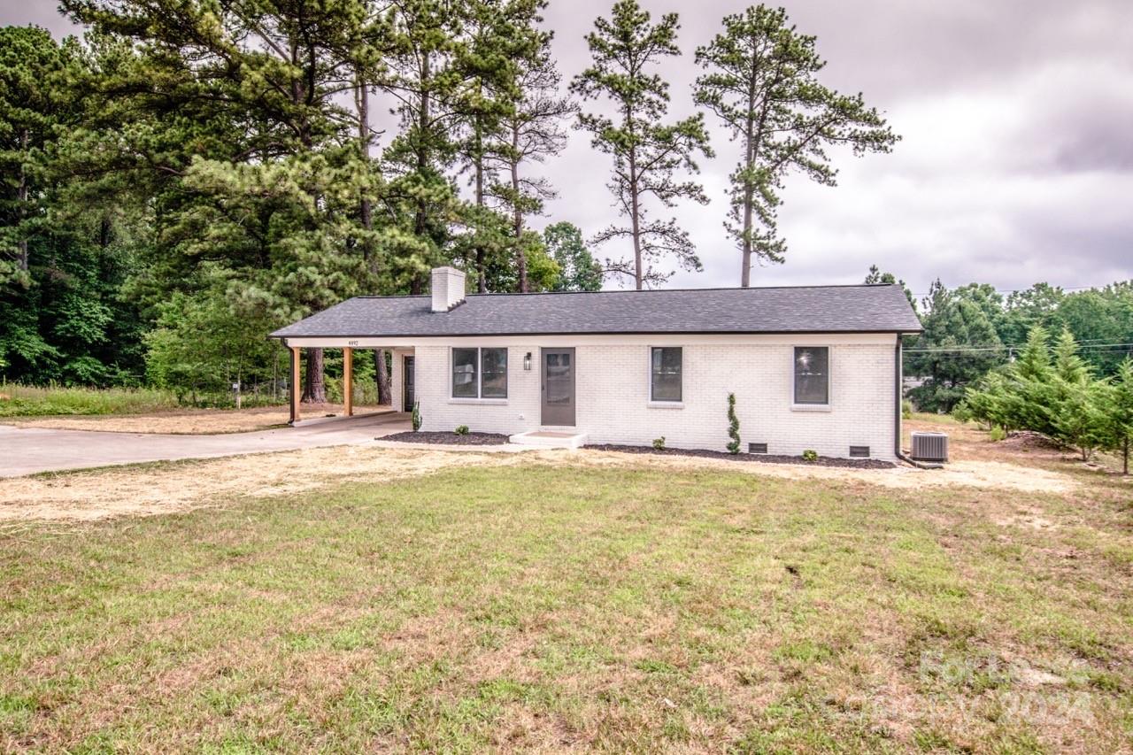 4892 Highway 16 Denver, NC 28037 - Photo 5 of 46 a front view of a house with swimming pool and porch