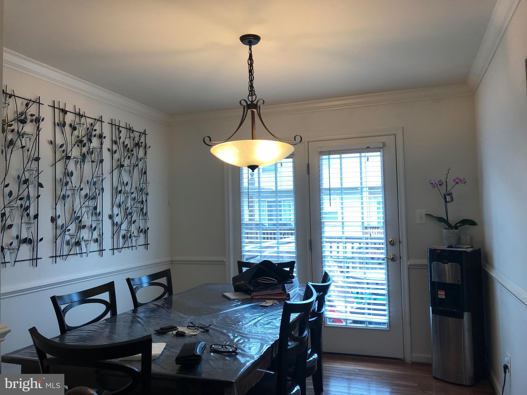 6389 Trips Way Springfield, VA 22150 - Photo 11 of 22 a view of a dining room with furniture window and wooden floor