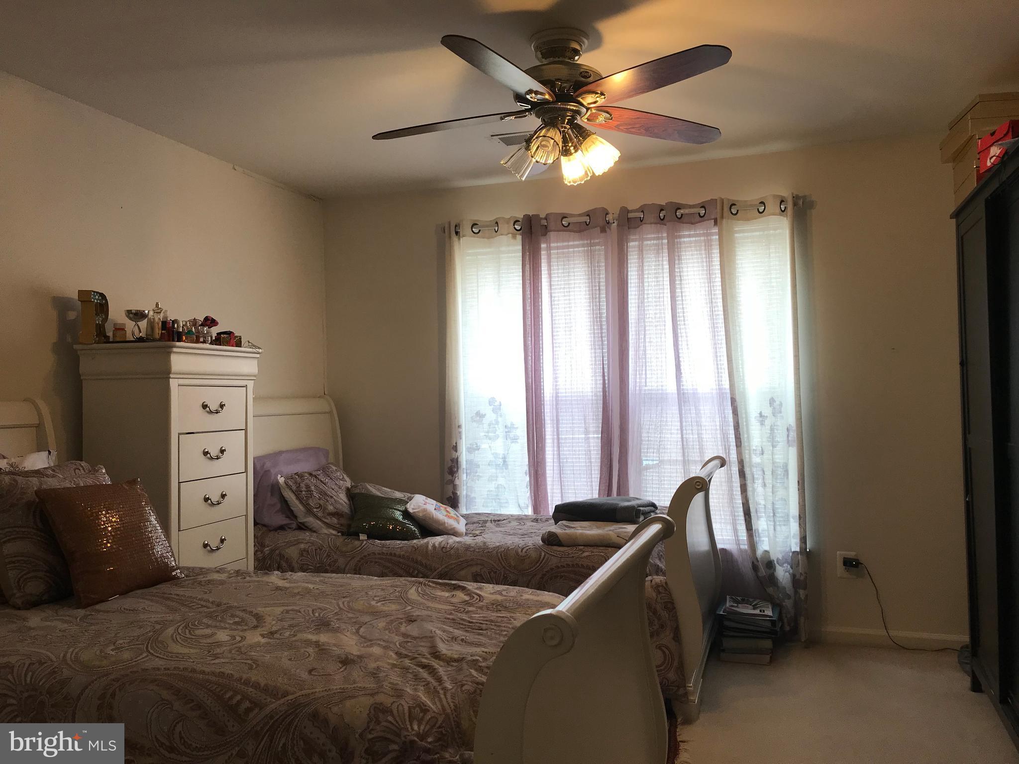 6389 Trips Way Springfield, VA 22150 - Photo 13 of 22 a bedroom with a bed and a chandelier