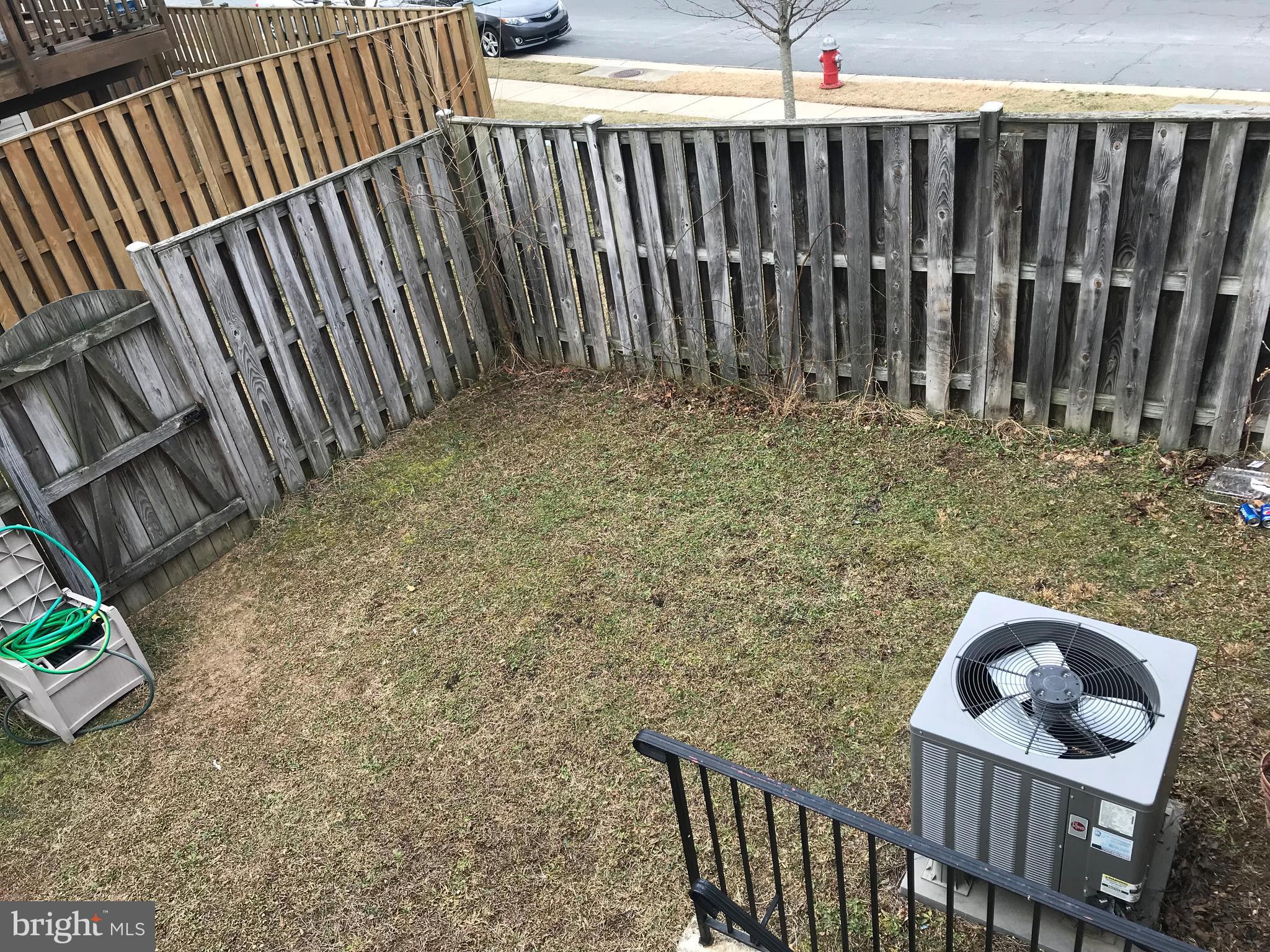 6389 Trips Way Springfield, VA 22150 - Photo 21 of 22 a view of a backyard with a wooden fence