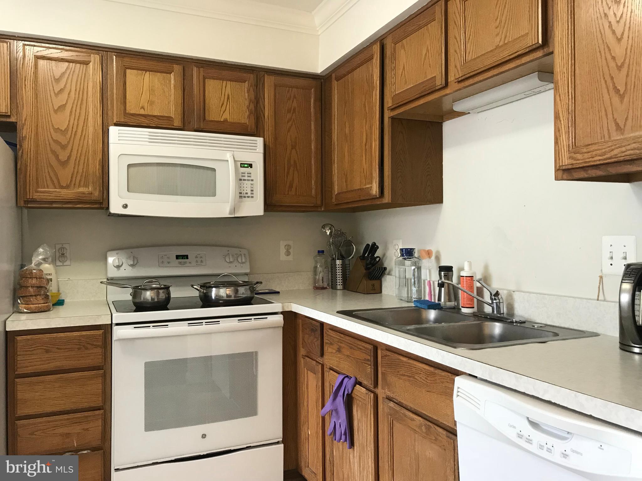 6389 Trips Way Springfield, VA 22150 - Photo 7 of 22 a kitchen with stainless steel appliances granite countertop a sink a stove and cabinets