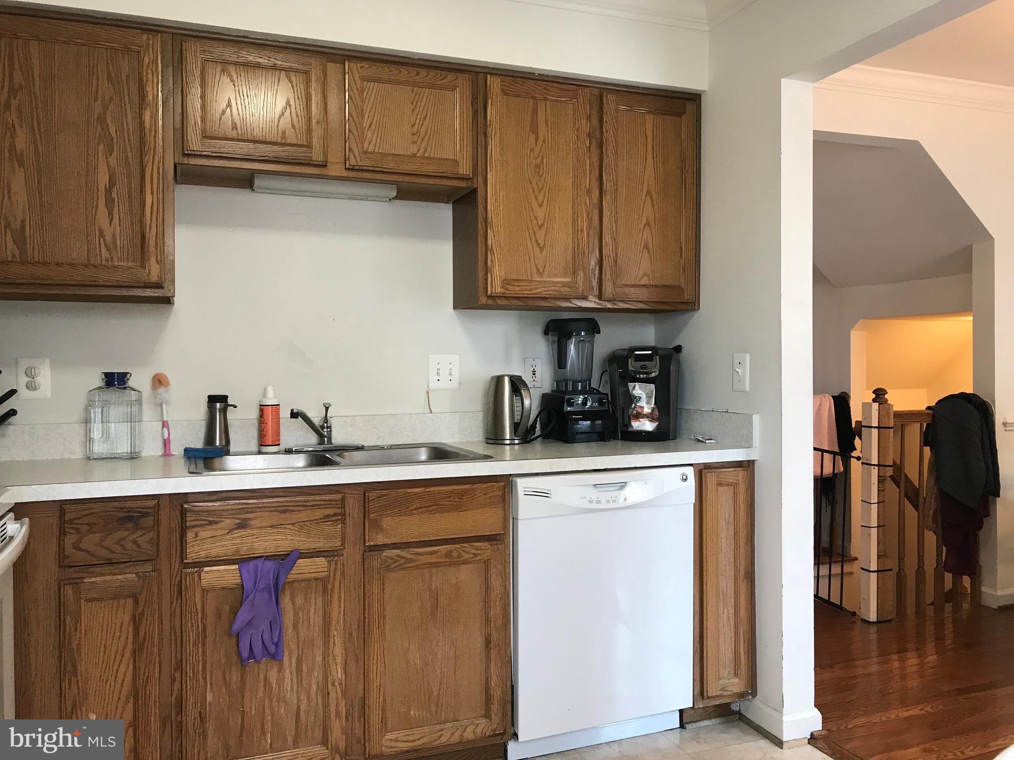 6389 Trips Way Springfield, VA 22150 - Photo 8 of 22 a kitchen with stainless steel appliances granite countertop a sink dishwasher stove and cabinets