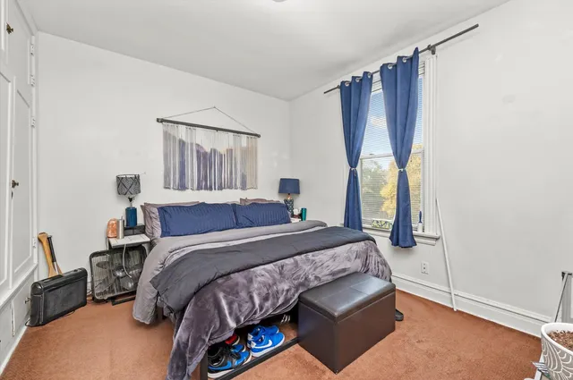 a bedroom with a bed and cabinets