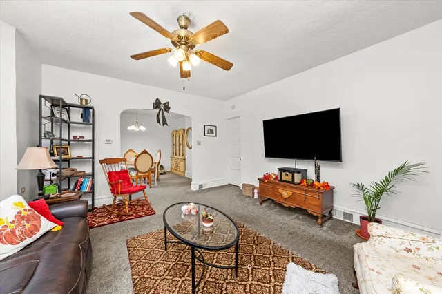 a dining room with furniture a chandelier and window