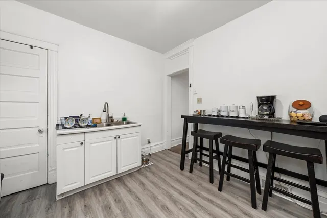 a kitchen with stainless steel appliances a stove refrigerator and cabinets
