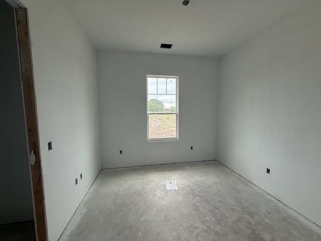 127 Riparian Elms Road Bertram, TX 78605 - Photo 17 of 22 A well-lit, unfinished room with a single window offering verdant outdoor views.