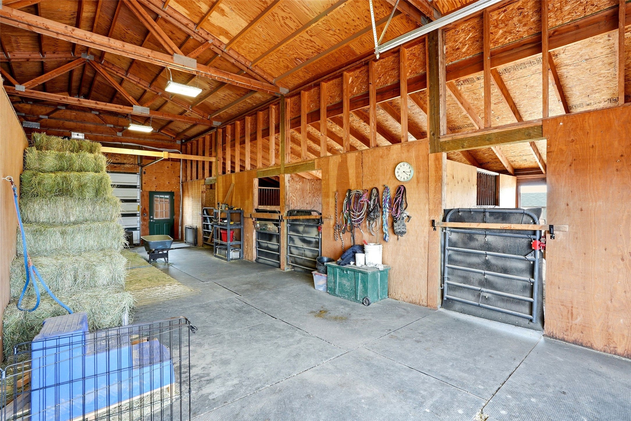 679 Hidden Valley Road North Florence, MT 59833 - Photo 55 of 85 Spacious barn interior featuring exposed wood beam construction and concrete flooring