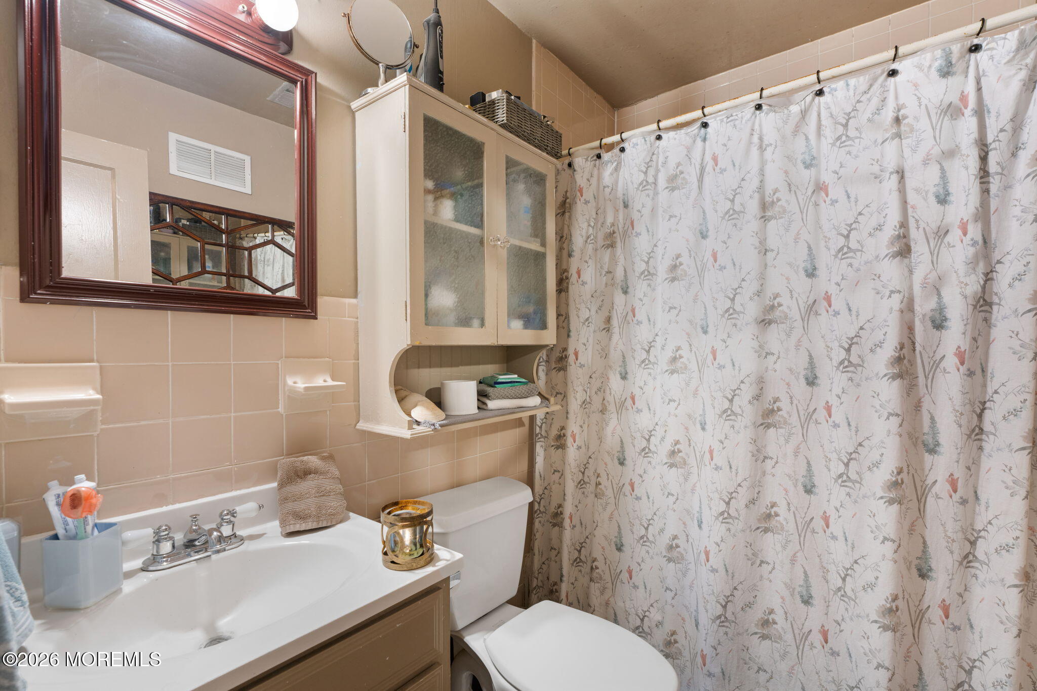 109 Harding Drive Brick, NJ 08724 - Photo 20 of 34 a bathroom with a sink a toilet and shower curtain