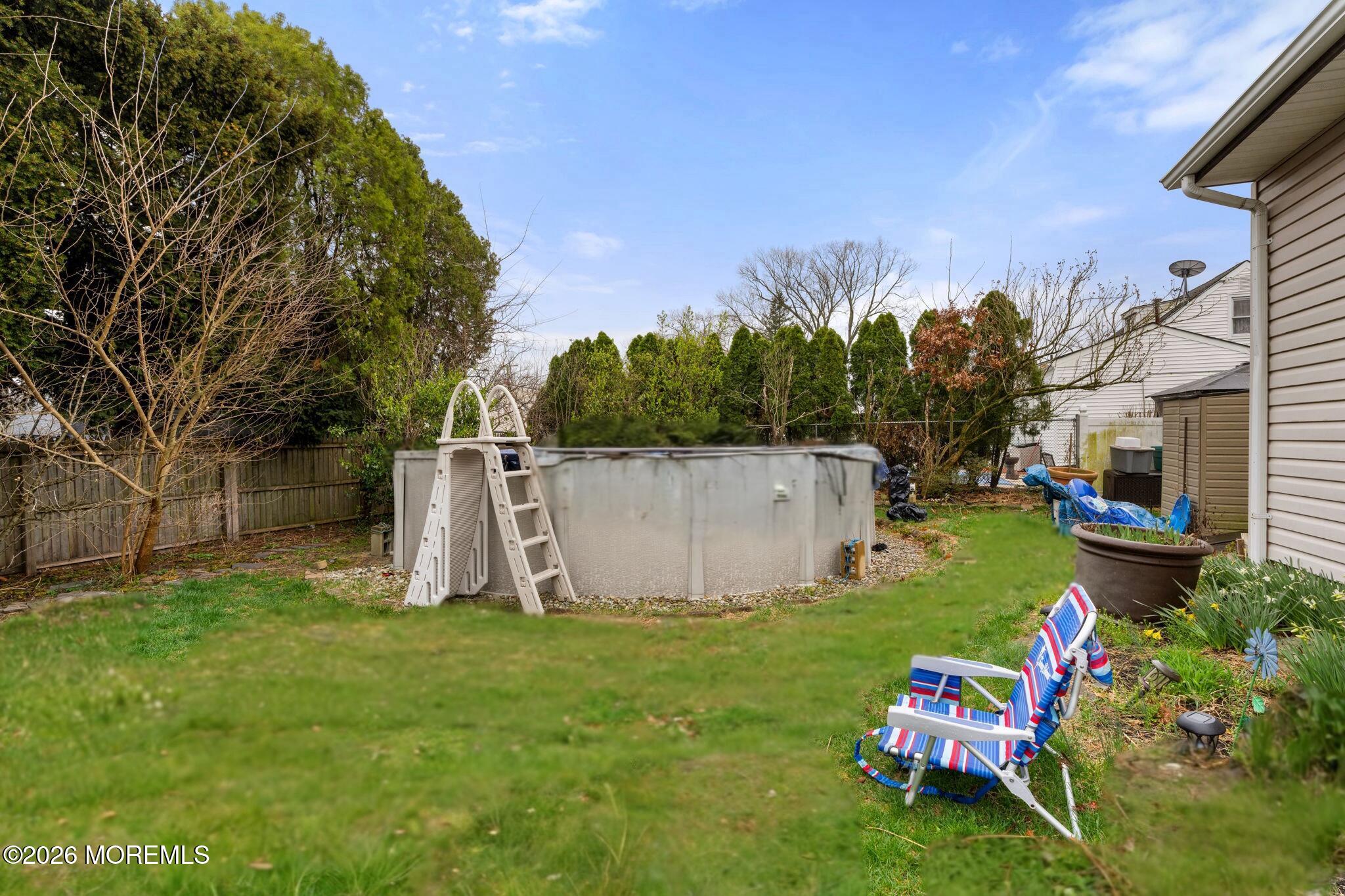 109 Harding Drive Brick, NJ 08724 - Photo 30 of 34 a backyard of a house with table and chairs plants and large tree