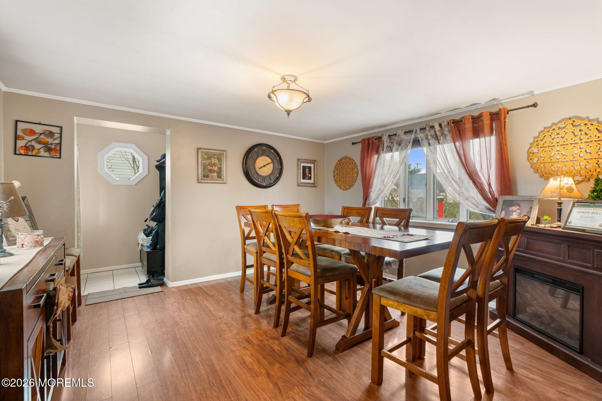 109 Harding Drive Brick, NJ 08724 - Photo 8 of 34 a view of a dining room and livingroom with furniture wooden floor a rug a clock and a clock