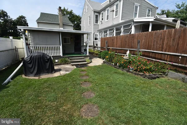 a view of a house with a yard and sitting area