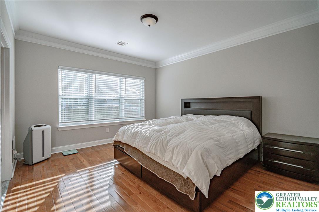 1490 East 7th Street Bethlehem, PA 18015 - Photo 13 of 22 a bed sitting in a bedroom next to a window