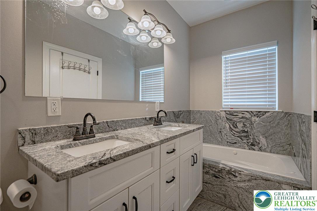 1490 East 7th Street Bethlehem, PA 18015 - Photo 15 of 22 a bathroom with a granite countertop sink and a mirror