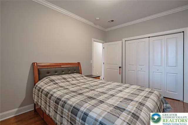 a bedroom with a bed and a closet