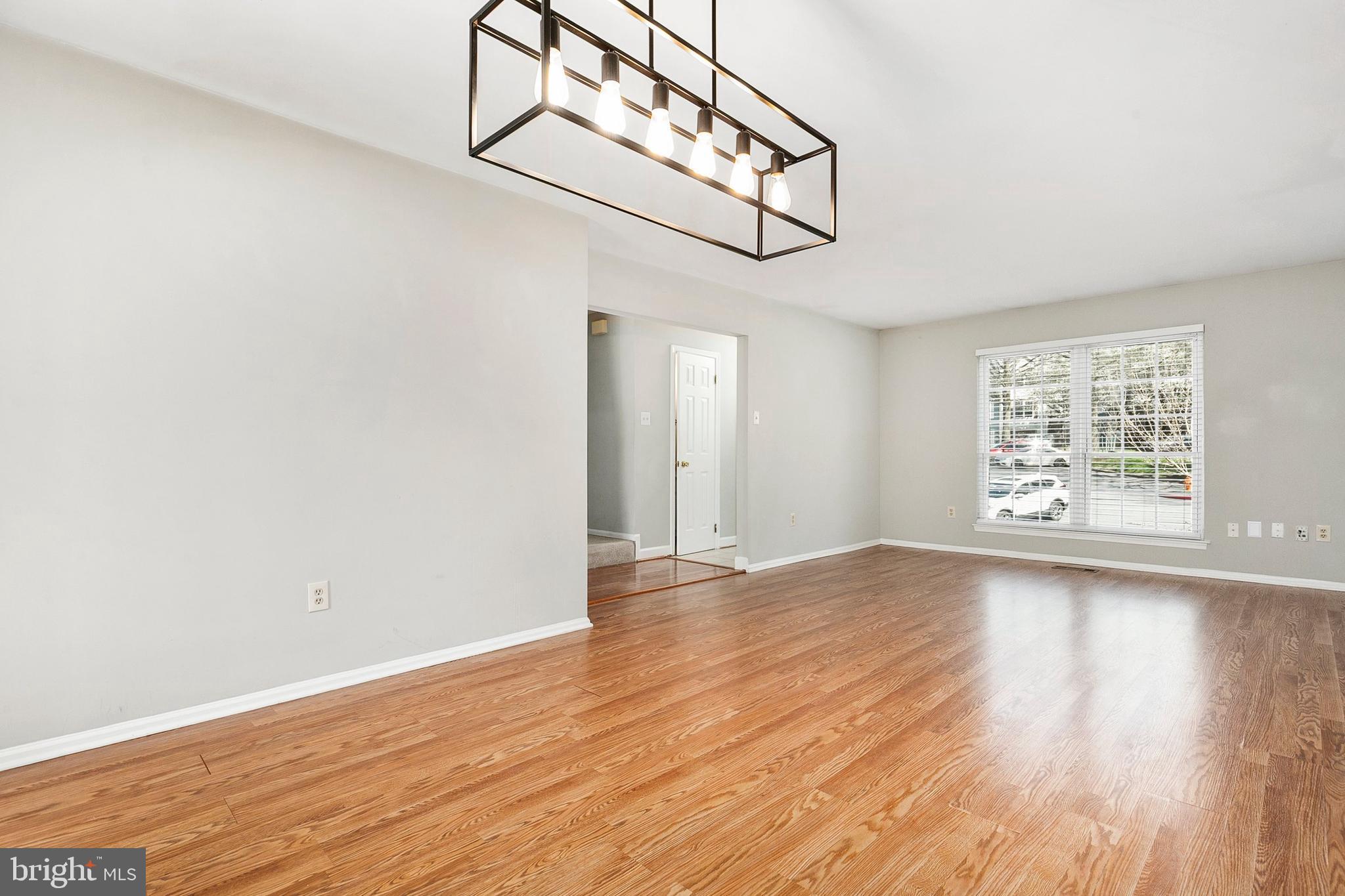 4762 Leyden Way Ellicott City, MD 21042 - Photo 11 of 58 a view of an empty room with wooden floor and a window