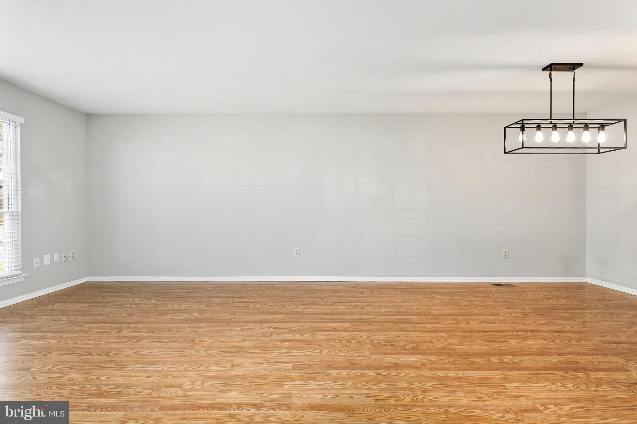 4762 Leyden Way Ellicott City, MD 21042 - Photo 12 of 58 a view of wooden floor and a chandelier fan in a room