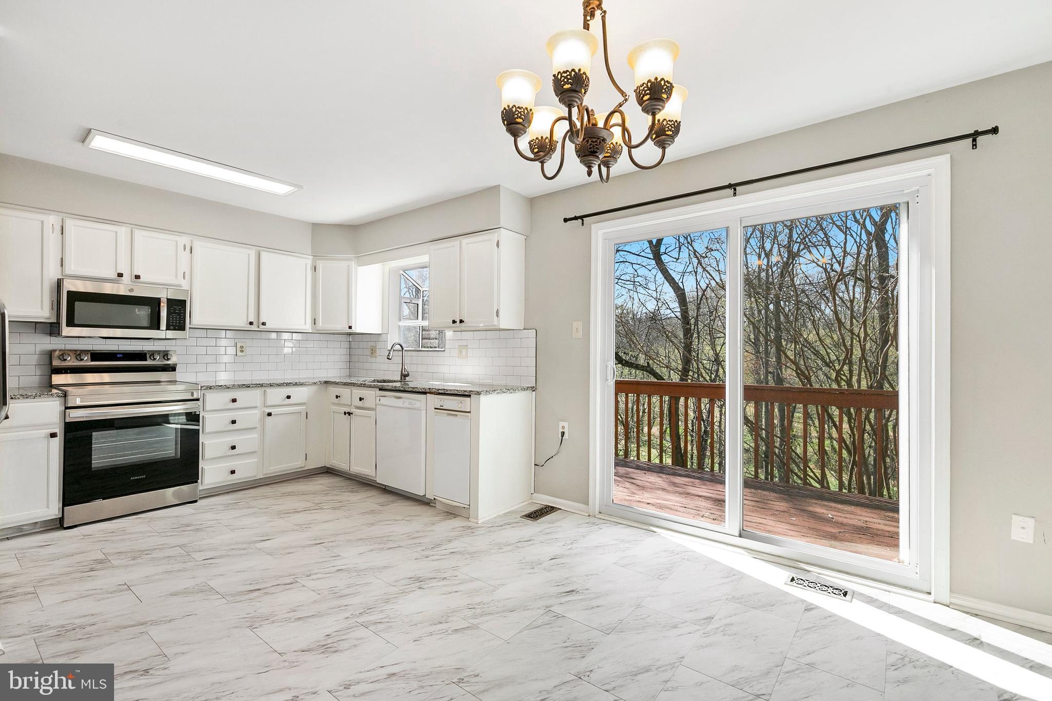 4762 Leyden Way Ellicott City, MD 21042 - Photo 14 of 58 a kitchen with stainless steel appliances granite countertop a stove oven and a refrigerator