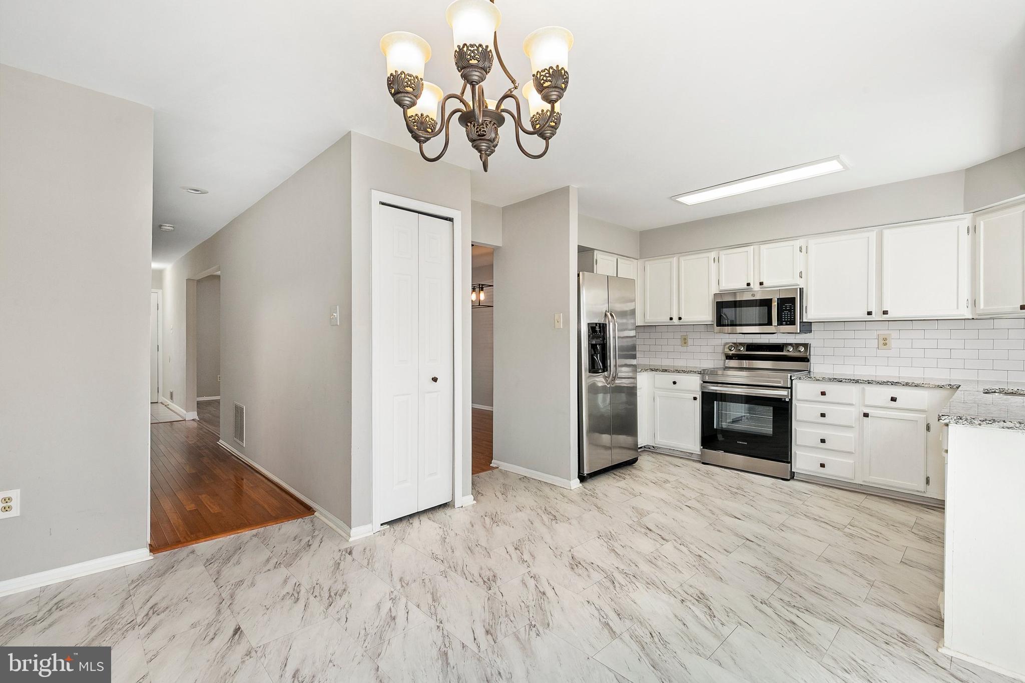 4762 Leyden Way Ellicott City, MD 21042 - Photo 15 of 58 a kitchen with stainless steel appliances granite countertop a refrigerator and a stove top oven