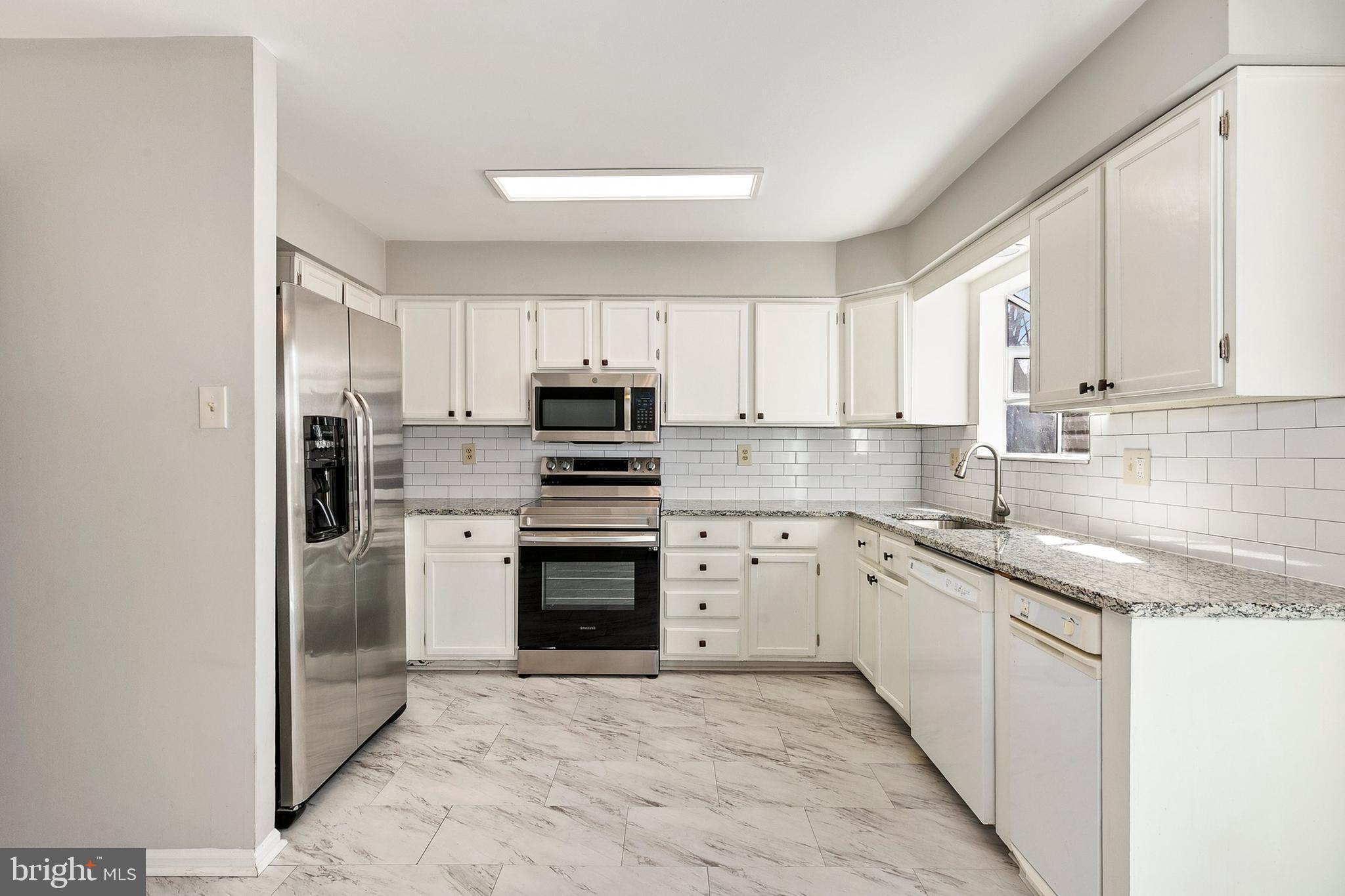 4762 Leyden Way Ellicott City, MD 21042 - Photo 16 of 58 a kitchen with granite countertop a sink stainless steel appliances and cabinets