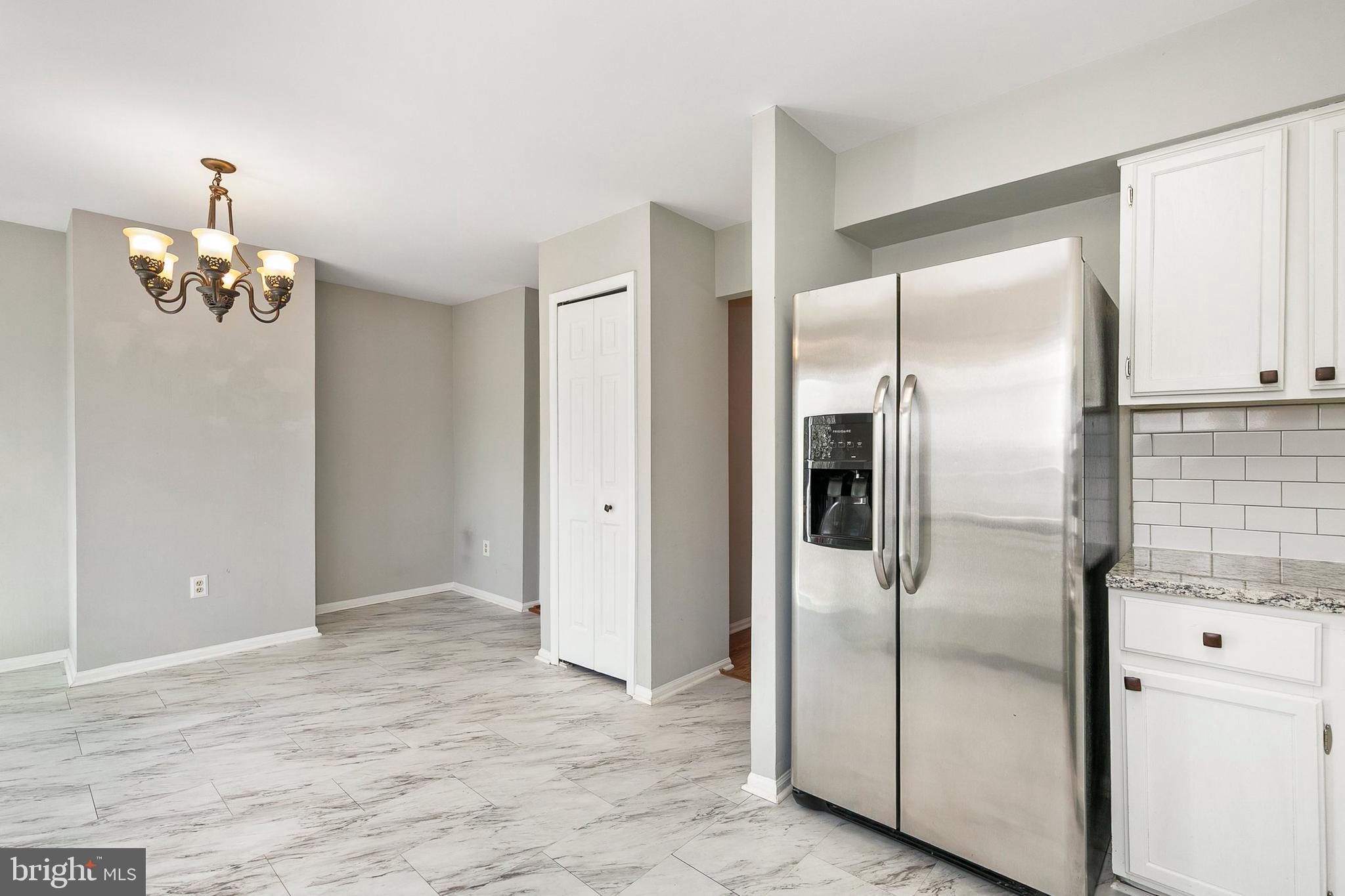 4762 Leyden Way Ellicott City, MD 21042 - Photo 19 of 58 a view of a refrigerator in kitchen and an empty room