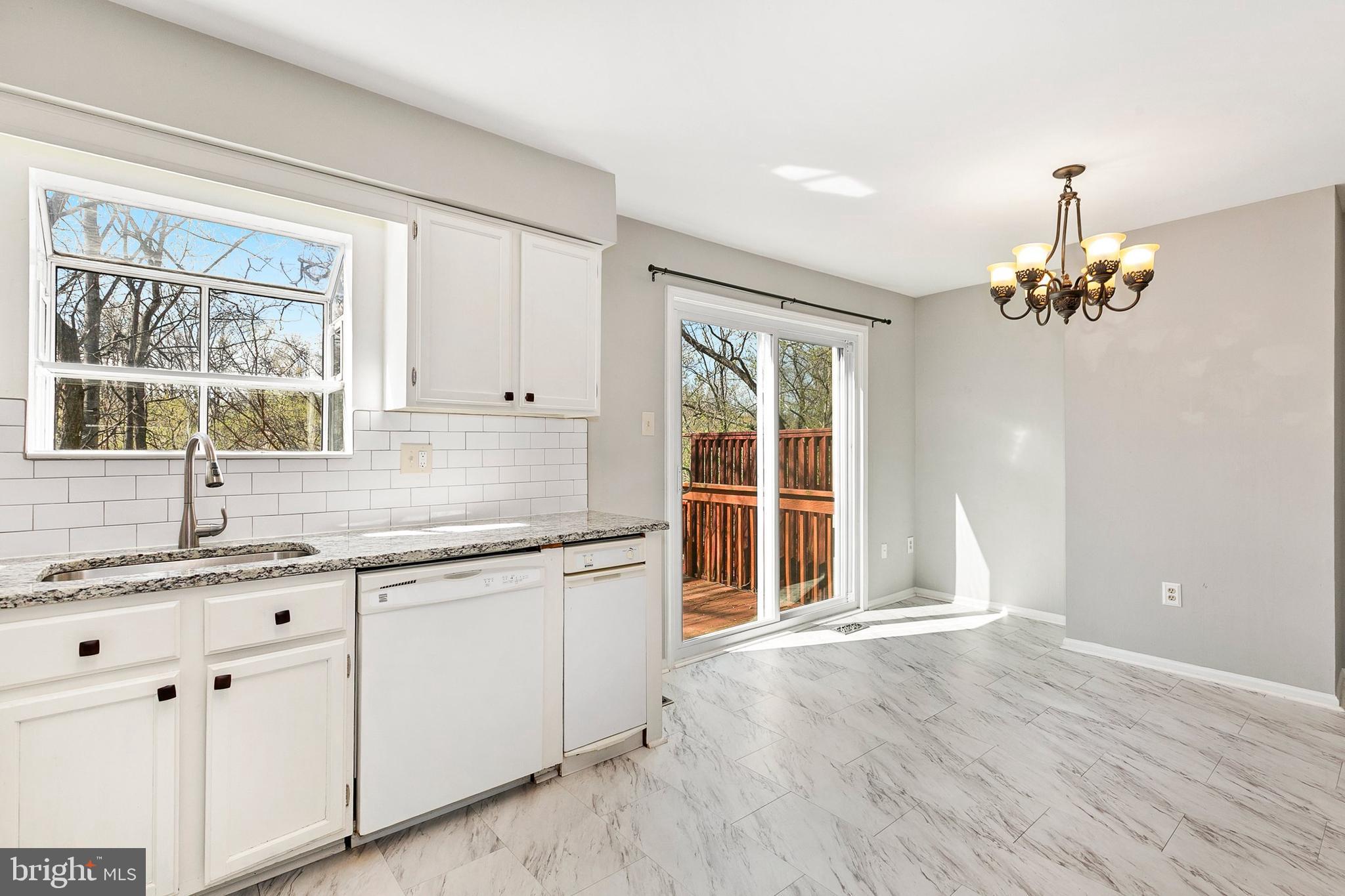4762 Leyden Way Ellicott City, MD 21042 - Photo 20 of 58 a kitchen with granite countertop a sink and cabinets