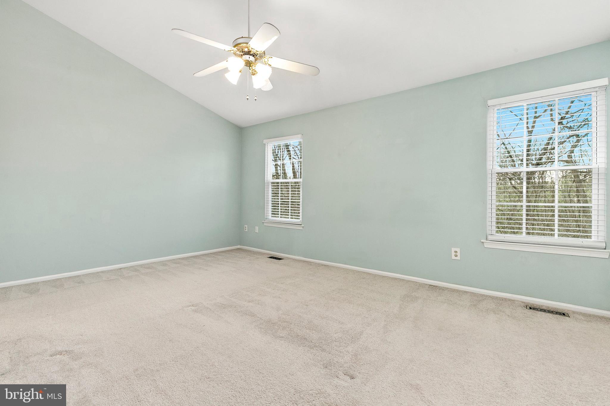 4762 Leyden Way Ellicott City, MD 21042 - Photo 26 of 58 an empty room with windows and chandelier fan