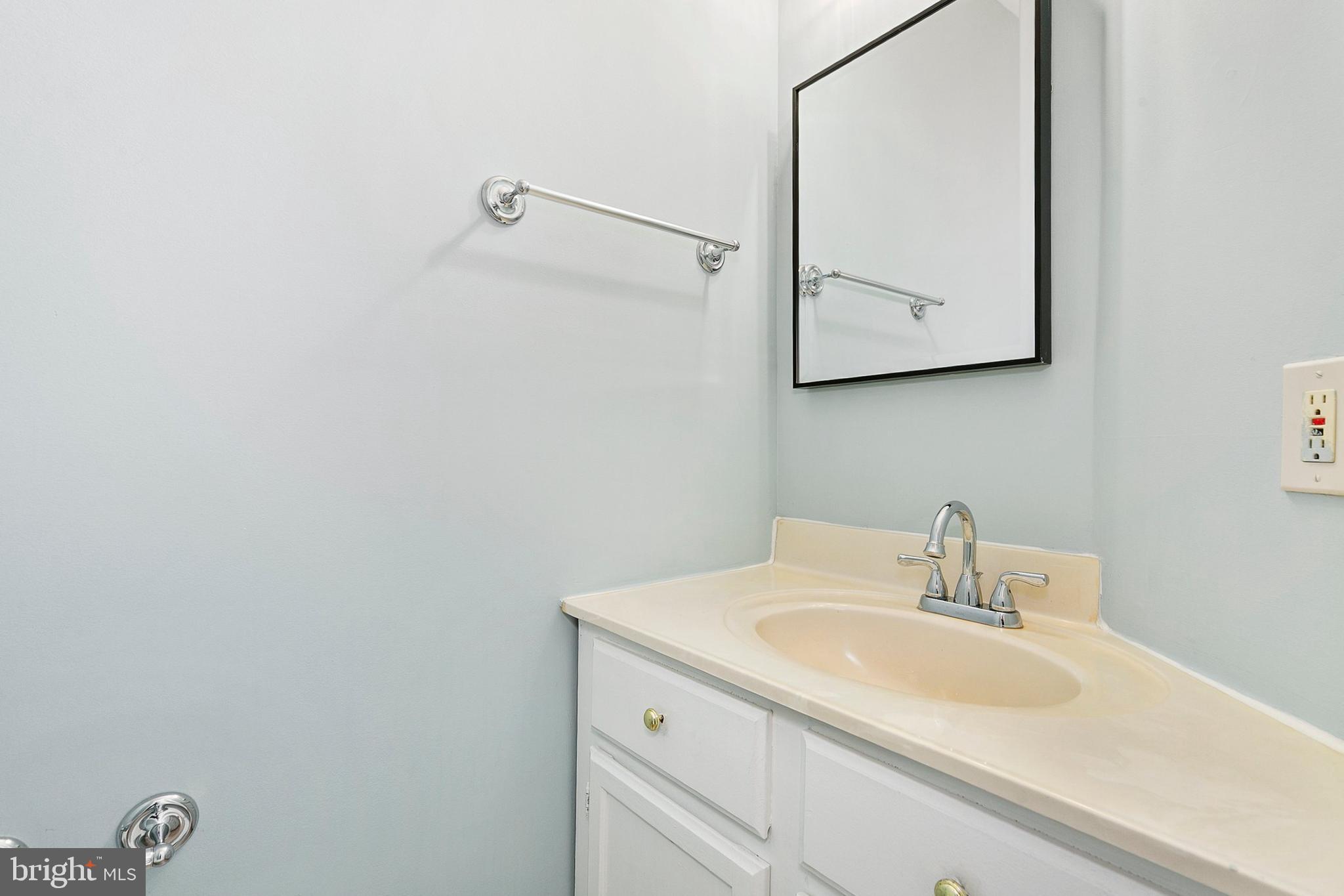 4762 Leyden Way Ellicott City, MD 21042 - Photo 36 of 58 a bathroom with a sink and mirror