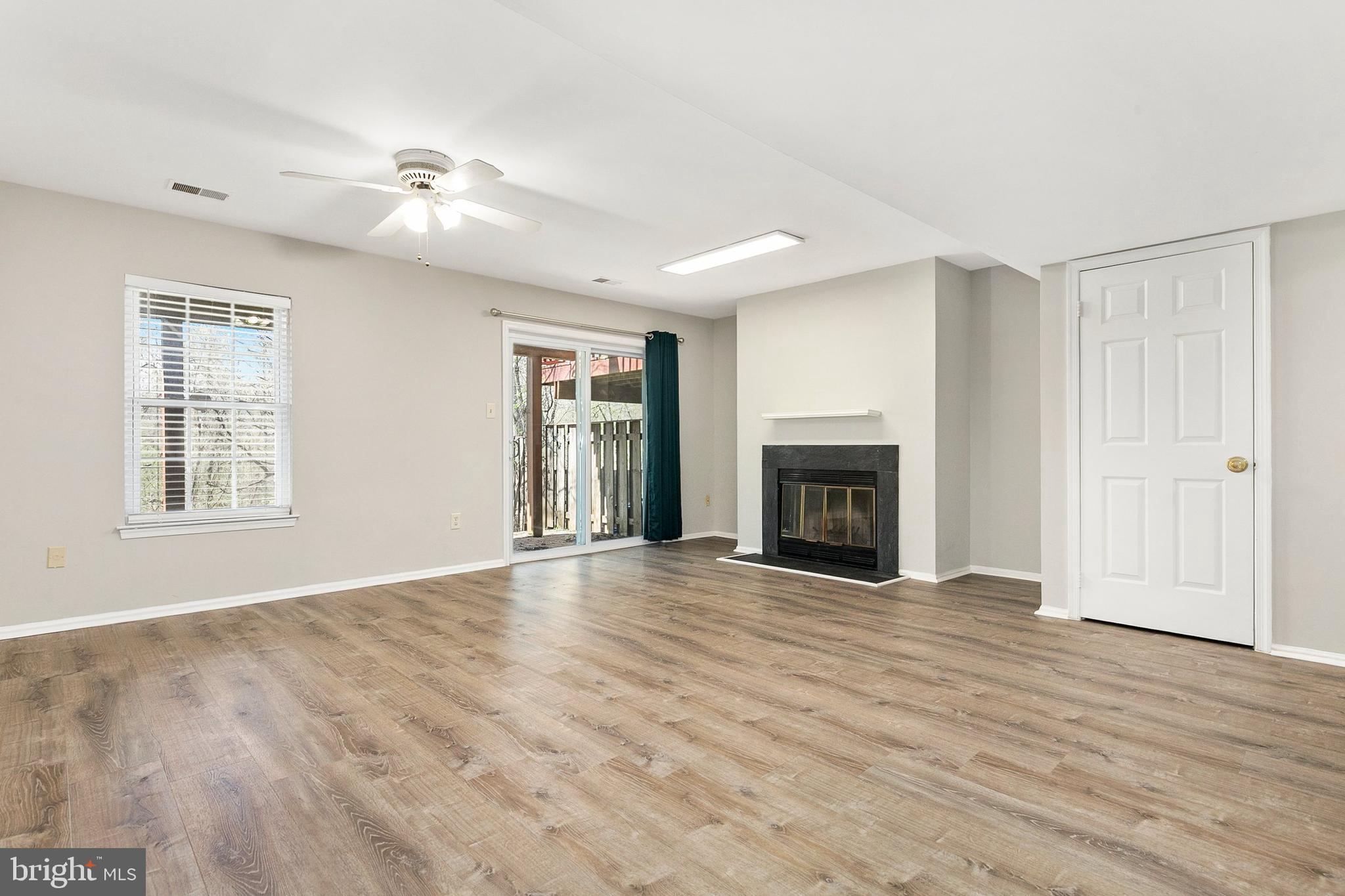 4762 Leyden Way Ellicott City, MD 21042 - Photo 42 of 58 a view of an empty room with wooden floor fireplace and a window