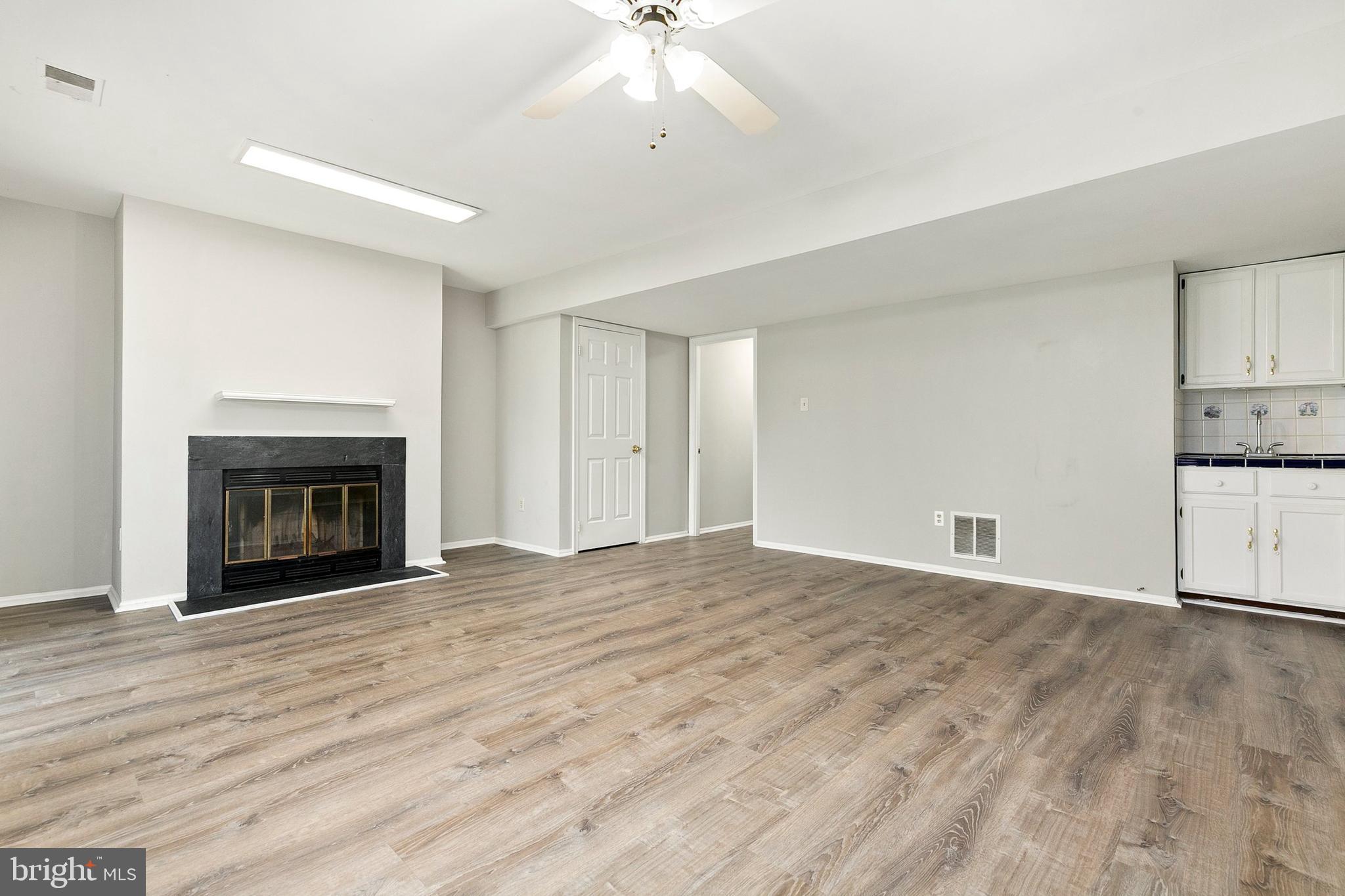 4762 Leyden Way Ellicott City, MD 21042 - Photo 44 of 58 a view of an empty room with a fireplace and a window