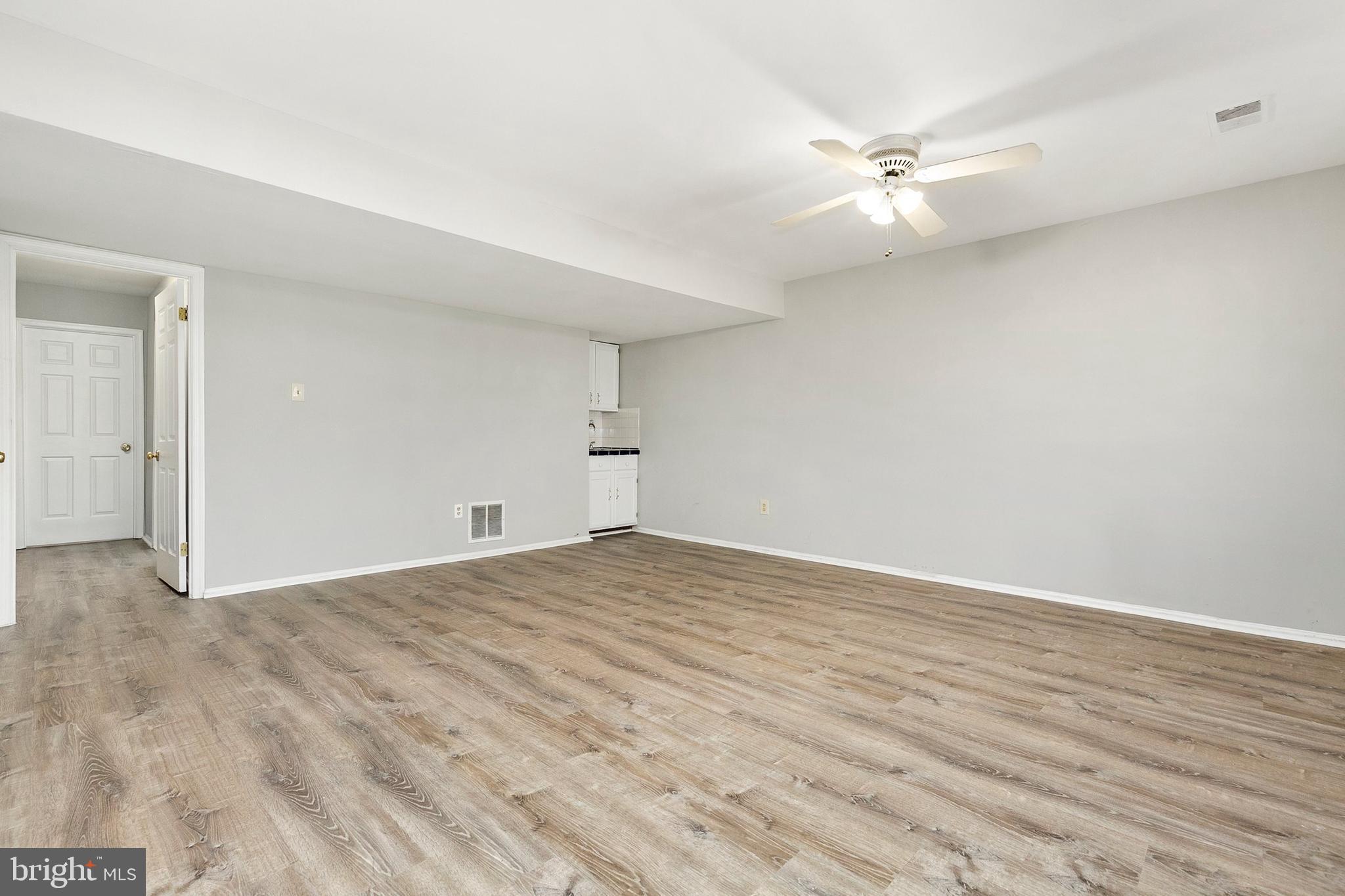 4762 Leyden Way Ellicott City, MD 21042 - Photo 45 of 58 an empty room with wooden floor and fan