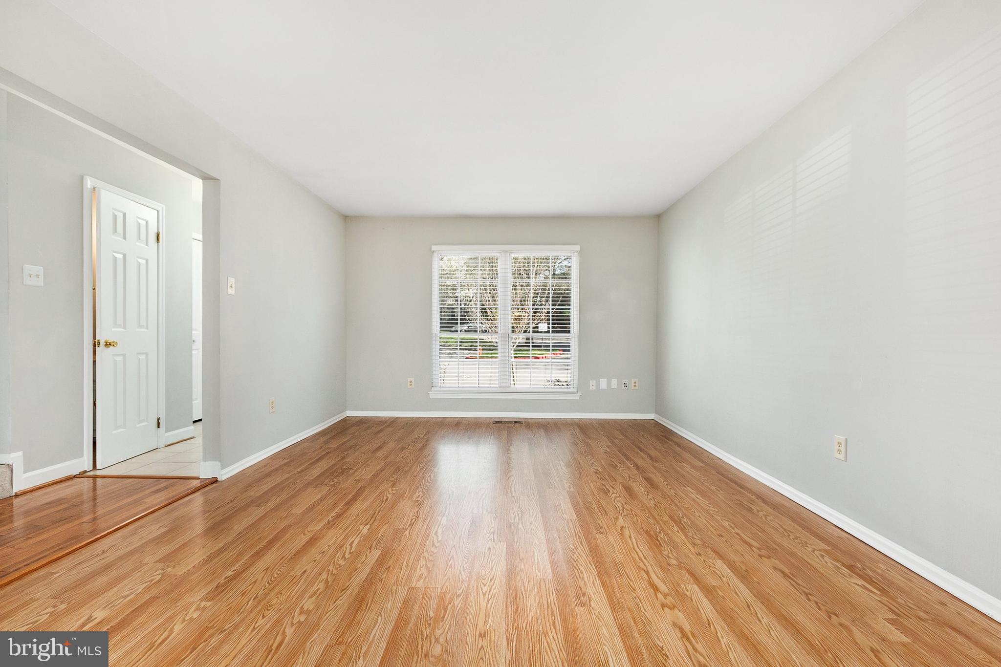 4762 Leyden Way Ellicott City, MD 21042 - Photo 5 of 58 wooden floor in an empty room with a window