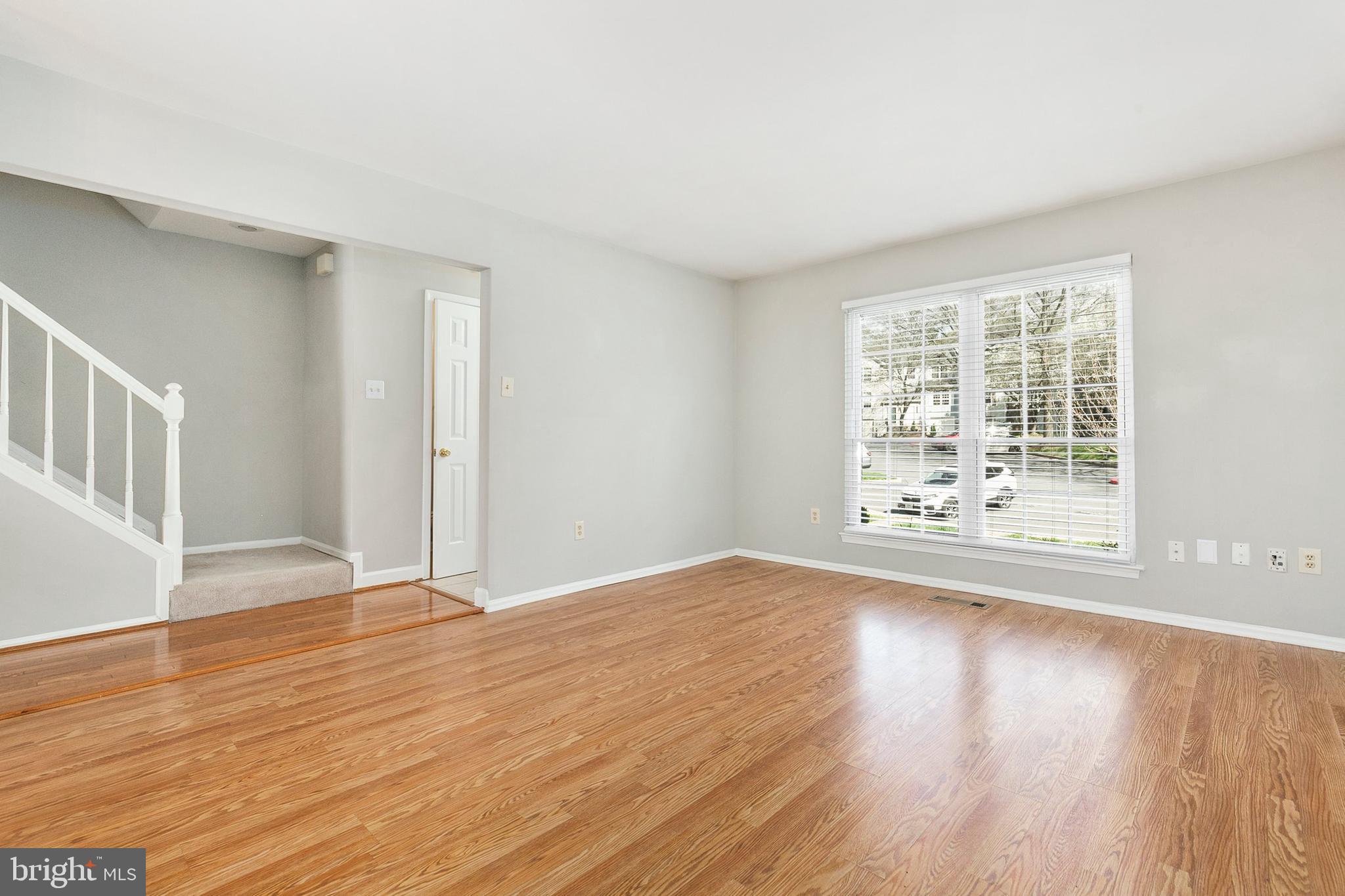 4762 Leyden Way Ellicott City, MD 21042 - Photo 7 of 58 a view of an empty room with wooden floor and a window