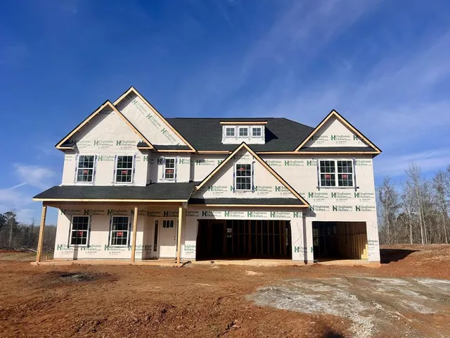 a front view of a house with yard and garage