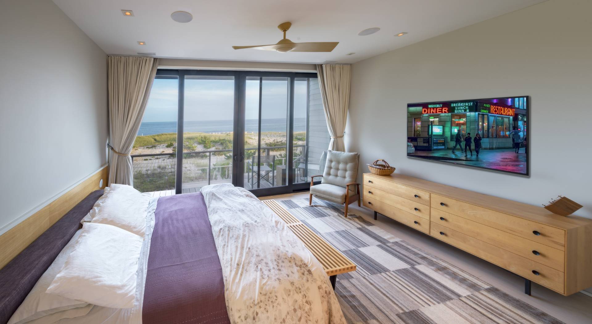 615 Dune Road Westhampton, NY 11978 - Photo 15 of 29 a bed room with a bed and a tv