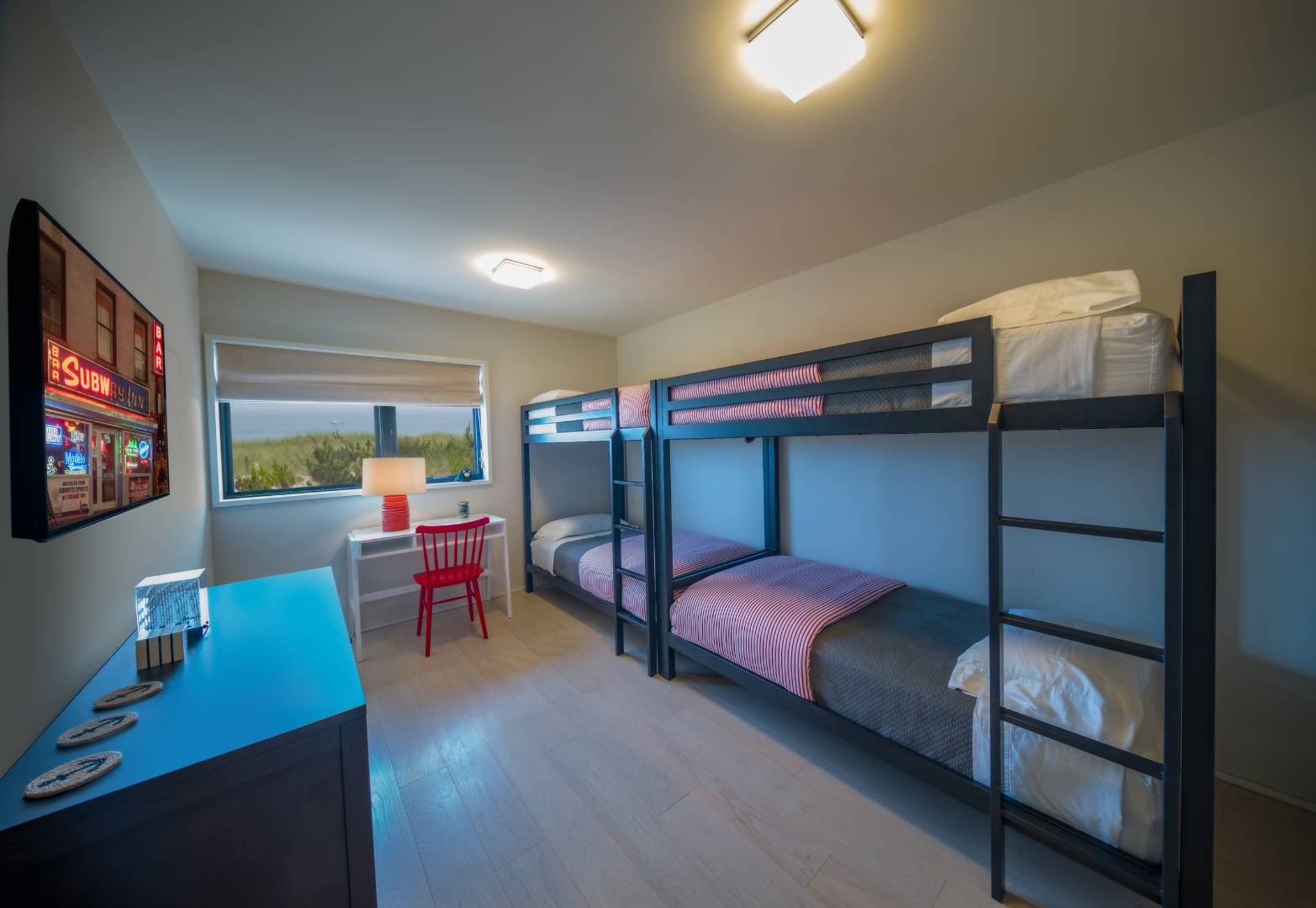 615 Dune Road Westhampton, NY 11978 - Photo 24 of 29 a bedroom with a bed and a flat screen tv