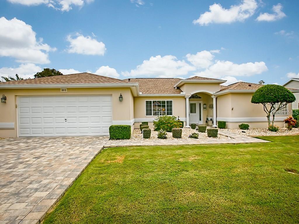 9910 Southeast 138th Loop Summerfield, FL 34491 - Photo 1 of 69 a front view of a house with swimming pool having outdoor seating