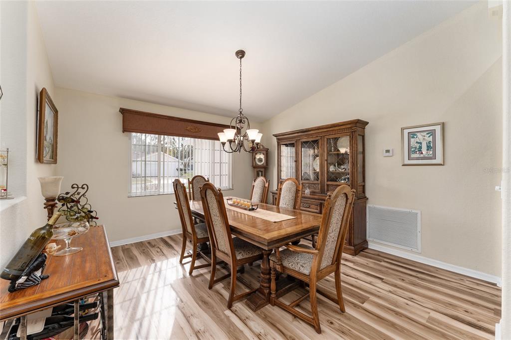 9910 Southeast 138th Loop Summerfield, FL 34491 - Photo 11 of 69 a view of a dining room with furniture window and wooden floor