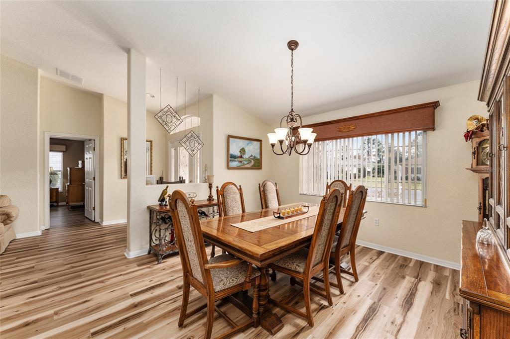 9910 Southeast 138th Loop Summerfield, FL 34491 - Photo 12 of 69 a view of a dining room with furniture window and wooden floor