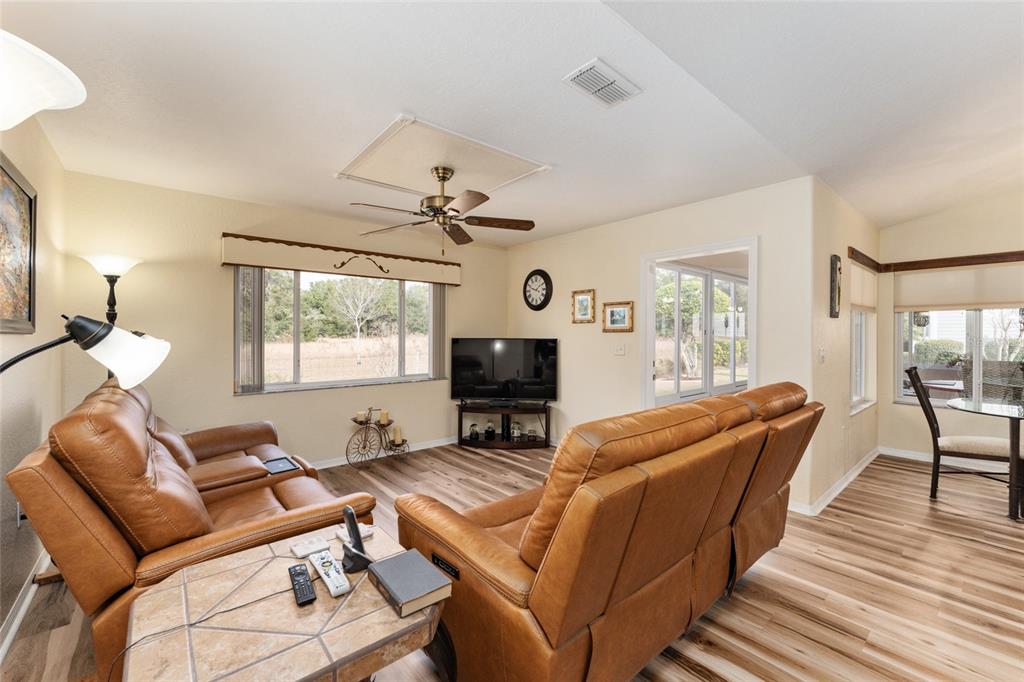 9910 Southeast 138th Loop Summerfield, FL 34491 - Photo 19 of 69 a living room with furniture and a flat screen tv