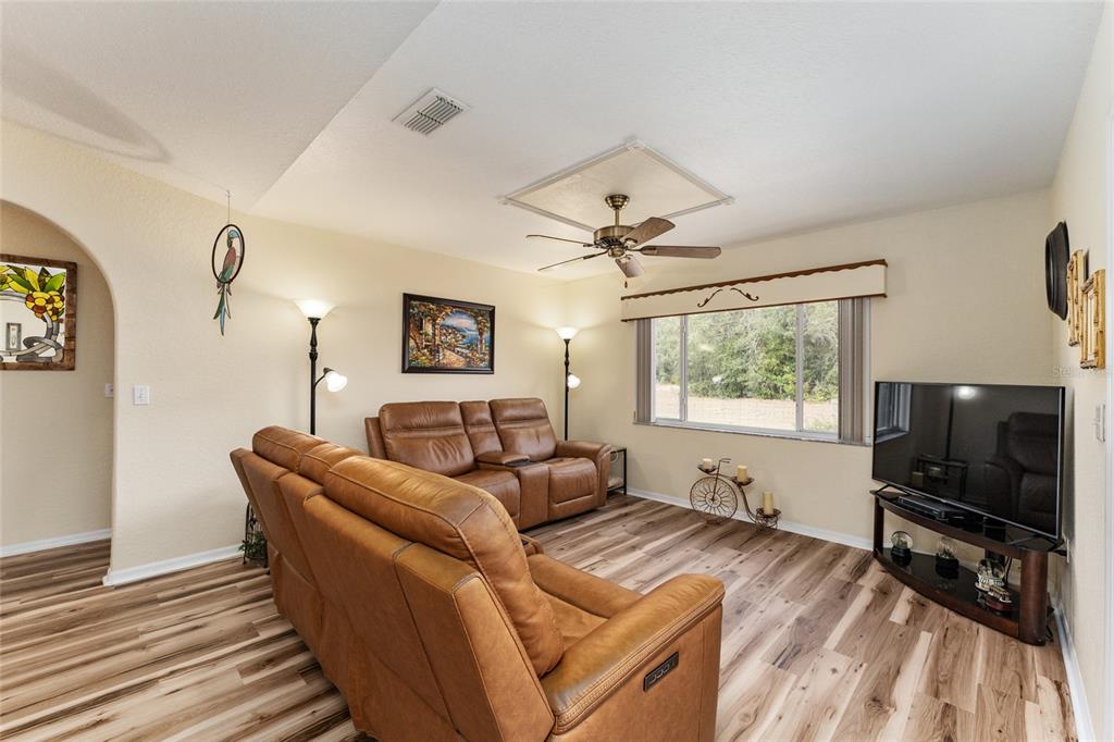 9910 Southeast 138th Loop Summerfield, FL 34491 - Photo 20 of 69 a living room with furniture and a flat screen tv