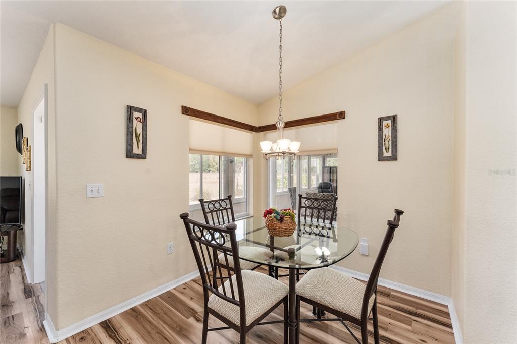 9910 Southeast 138th Loop Summerfield, FL 34491 - Photo 21 of 69 a view of a dining room with furniture and wooden floor