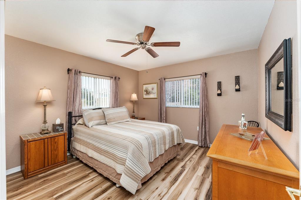 9910 Southeast 138th Loop Summerfield, FL 34491 - Photo 29 of 69 a bedroom with a bed and wooden floor