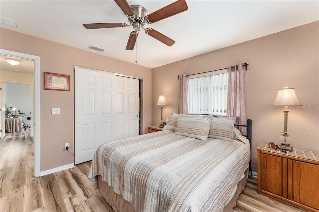 9910 Southeast 138th Loop Summerfield, FL 34491 - Photo 30 of 69 a bedroom with a bed and a chandelier