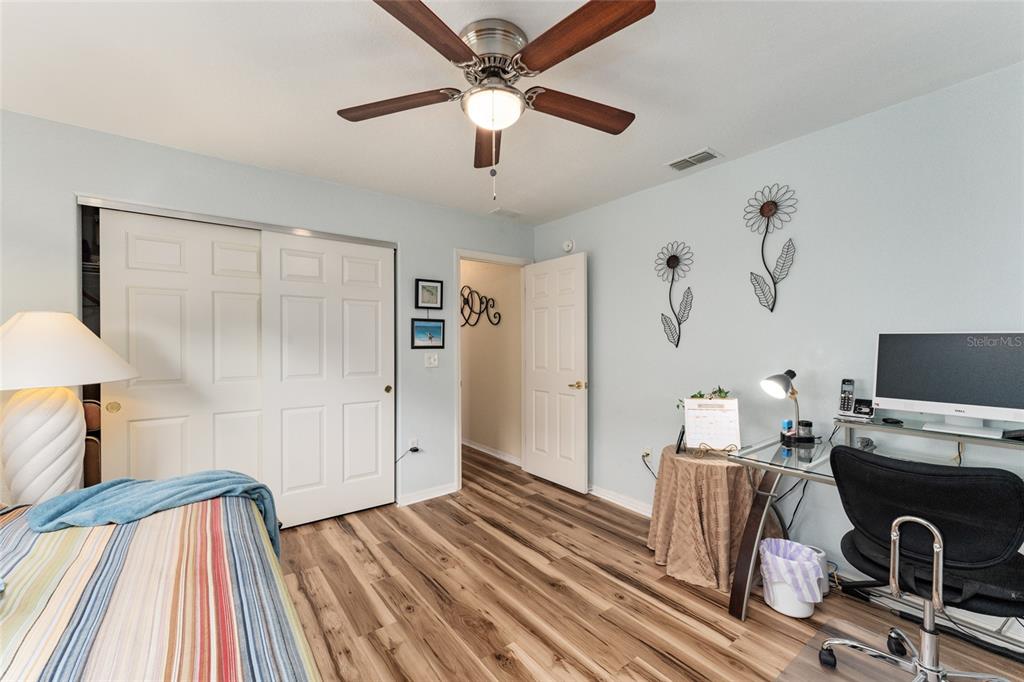 9910 Southeast 138th Loop Summerfield, FL 34491 - Photo 34 of 69 a view of a workspace with wooden floor and a ceiling fan