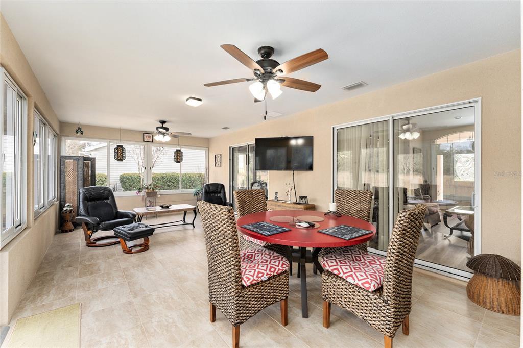 9910 Southeast 138th Loop Summerfield, FL 34491 - Photo 36 of 69 a living room with furniture a flat screen tv and a large window