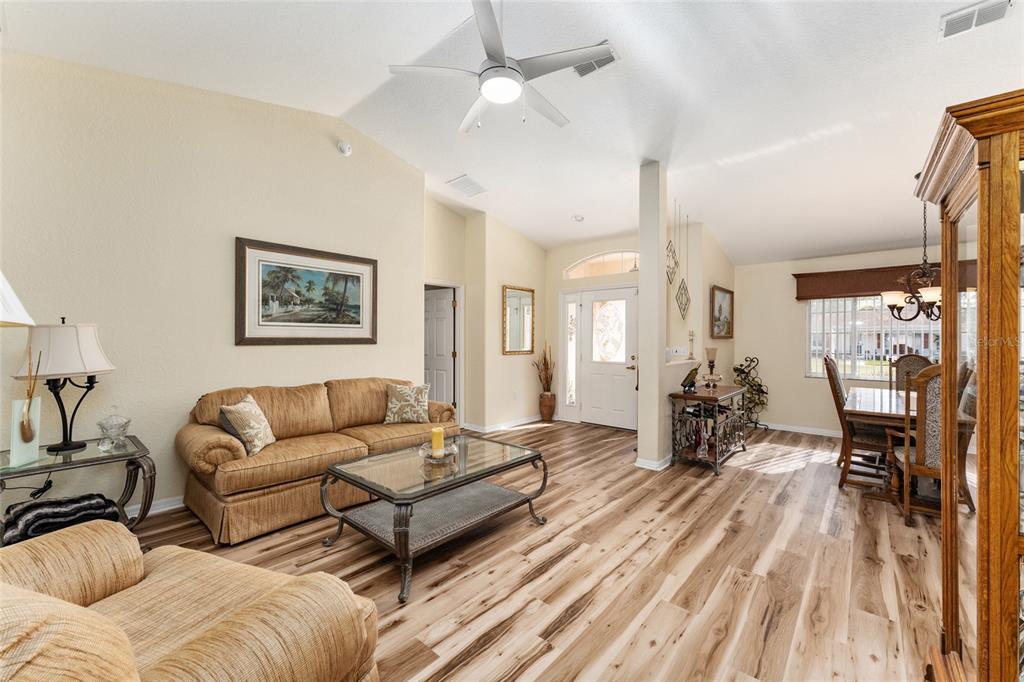 9910 Southeast 138th Loop Summerfield, FL 34491 - Photo 8 of 69 a living room with furniture and a wooden floor