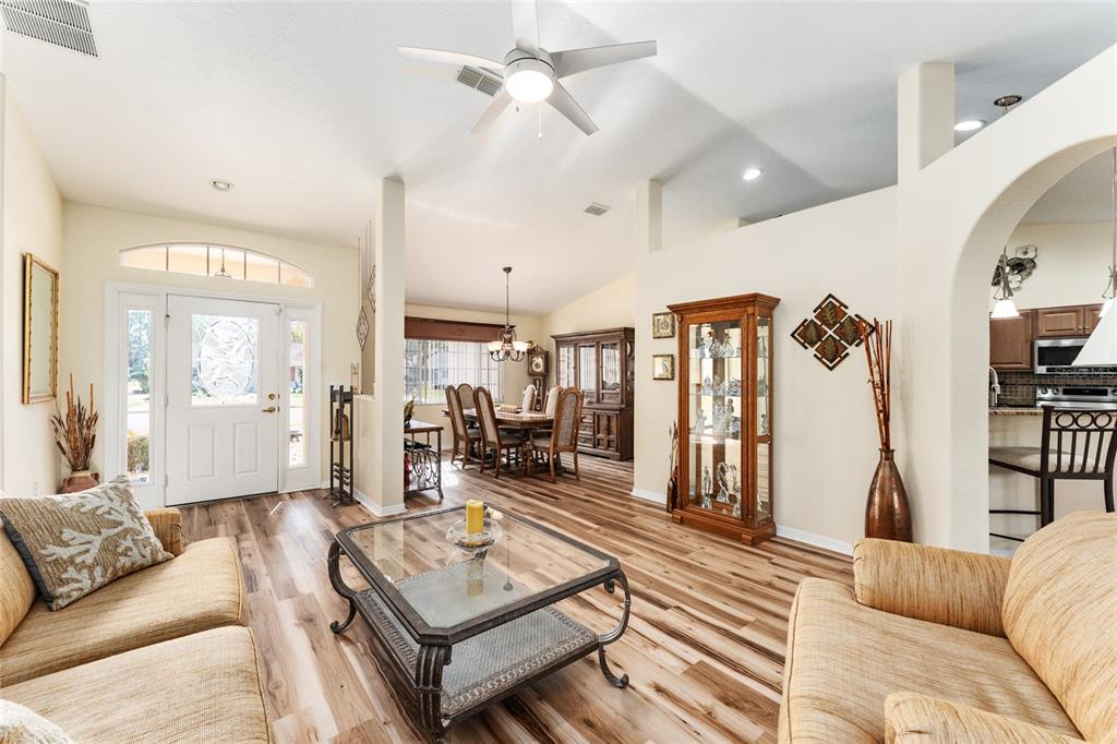 9910 Southeast 138th Loop Summerfield, FL 34491 - Photo 9 of 69 a living room with furniture ceiling fan and a rug